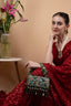 Black handcrafted potli bag with sequin cutdana beadwork stones and drawstring closure for festive and wedding wear