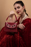 Red mirror work clutch bag with pearl and bead embellishments and suede lining for wedding and festive wear