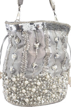 Silver potli bag with cutdana pearl and sequin embellishments on raw silk fabric with tassel for wedding and festive wear