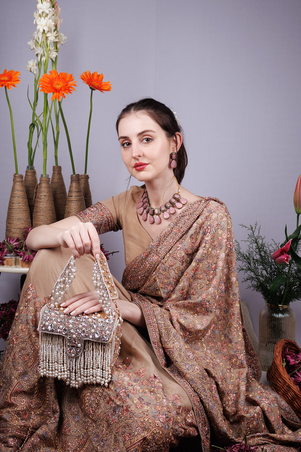 Gold handcrafted evening handbag with stone pearl bead embellishment fringe detail top handle and detachable chain wedding festive wear