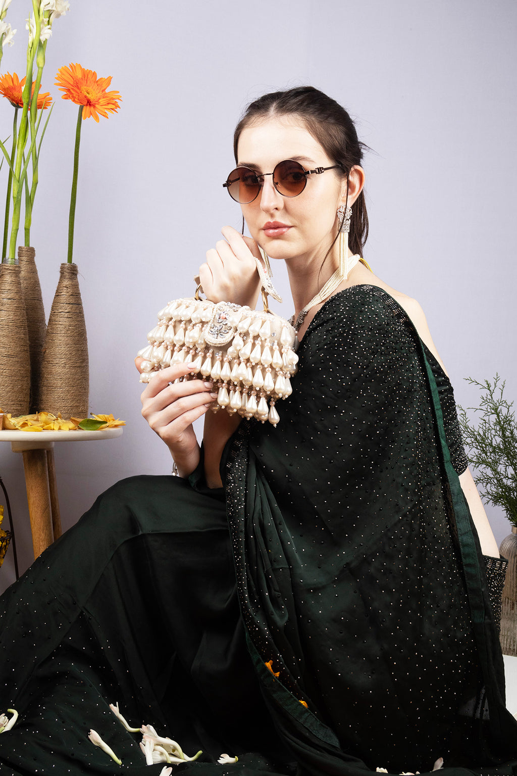 Handcrafted pearl clutch bag with traditional pearl detailing short handle and detachable shoulder chain for festive and wedding occasions
