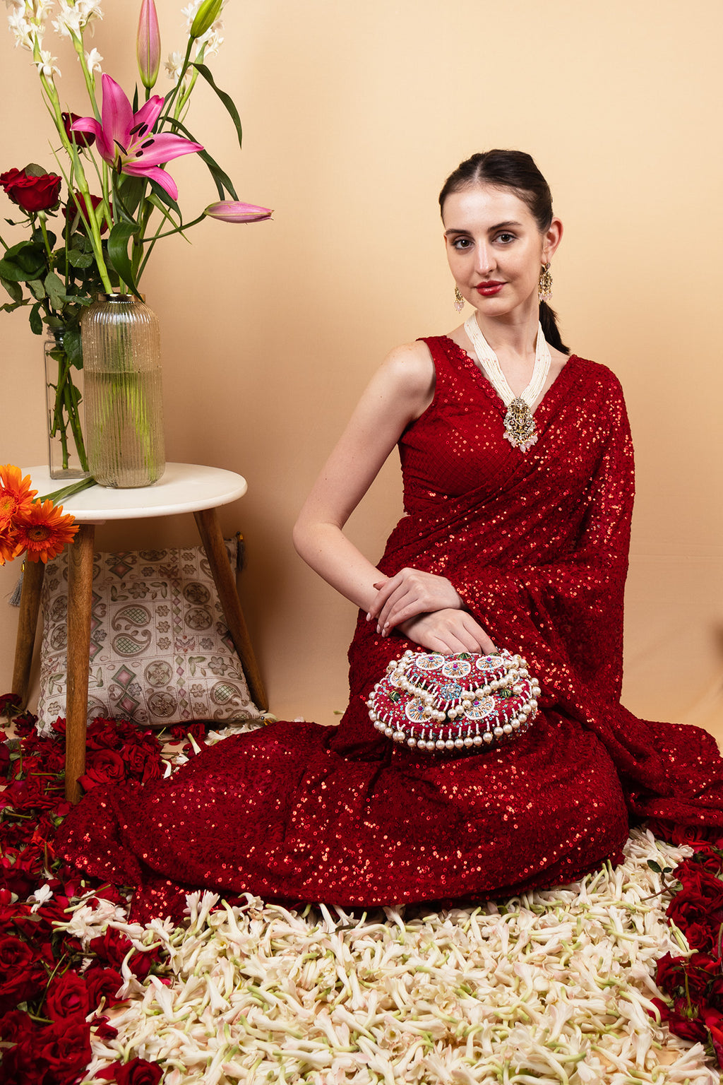 Red handcrafted potli bag with beads sequins zari embroidery and pearl detailing with chain strap for wedding and festive wear