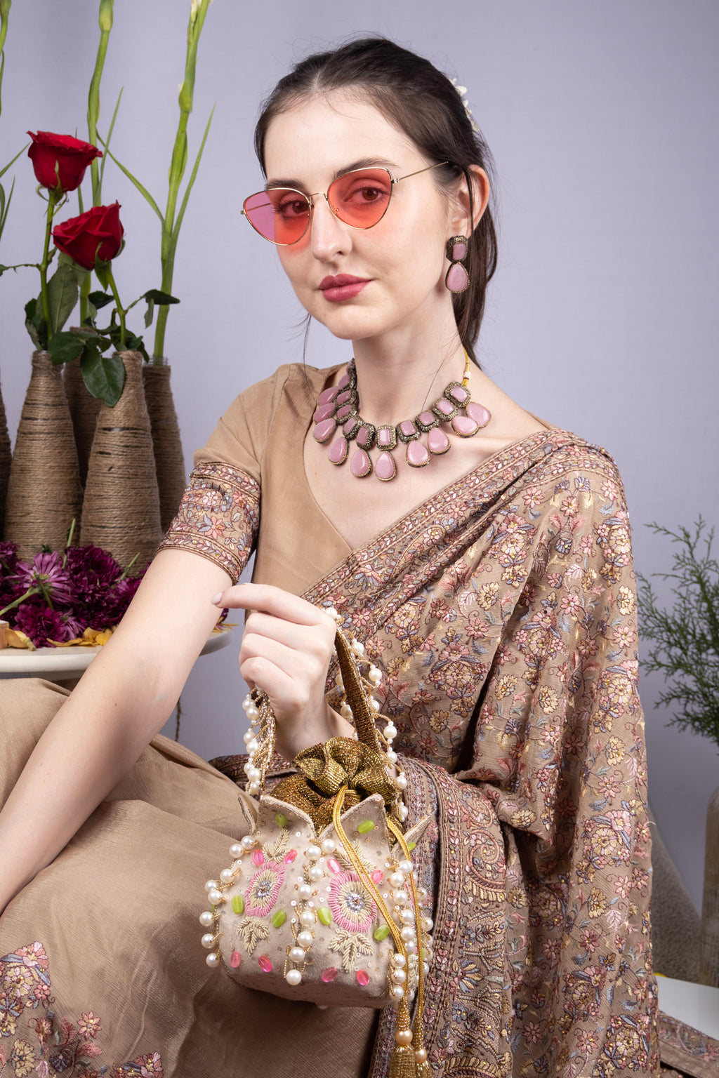 Beige gold lotus shape pearl zardosi suede potli bag with floral embroidery for wedding and bridal wear