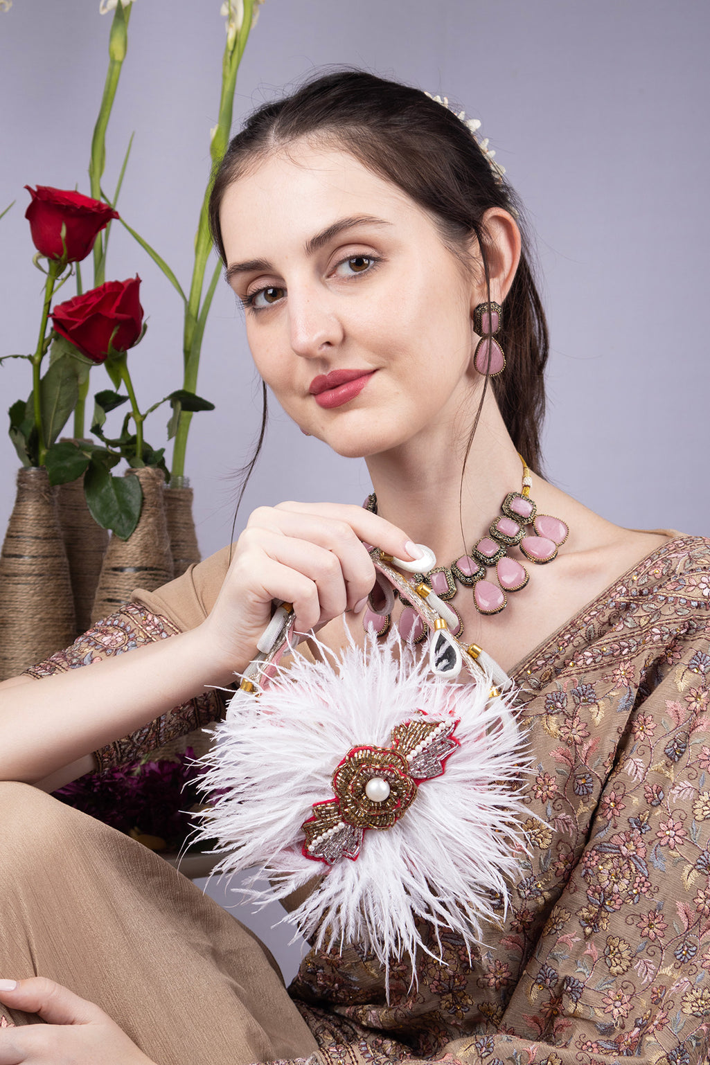 Blush pink feather mini bag with pearl bead embroidery floral motif suede lining and decorative handle for party and wedding wear