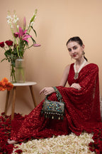 Black handcrafted potli bag with sequin cutdana beadwork stones and drawstring closure for festive and wedding wear