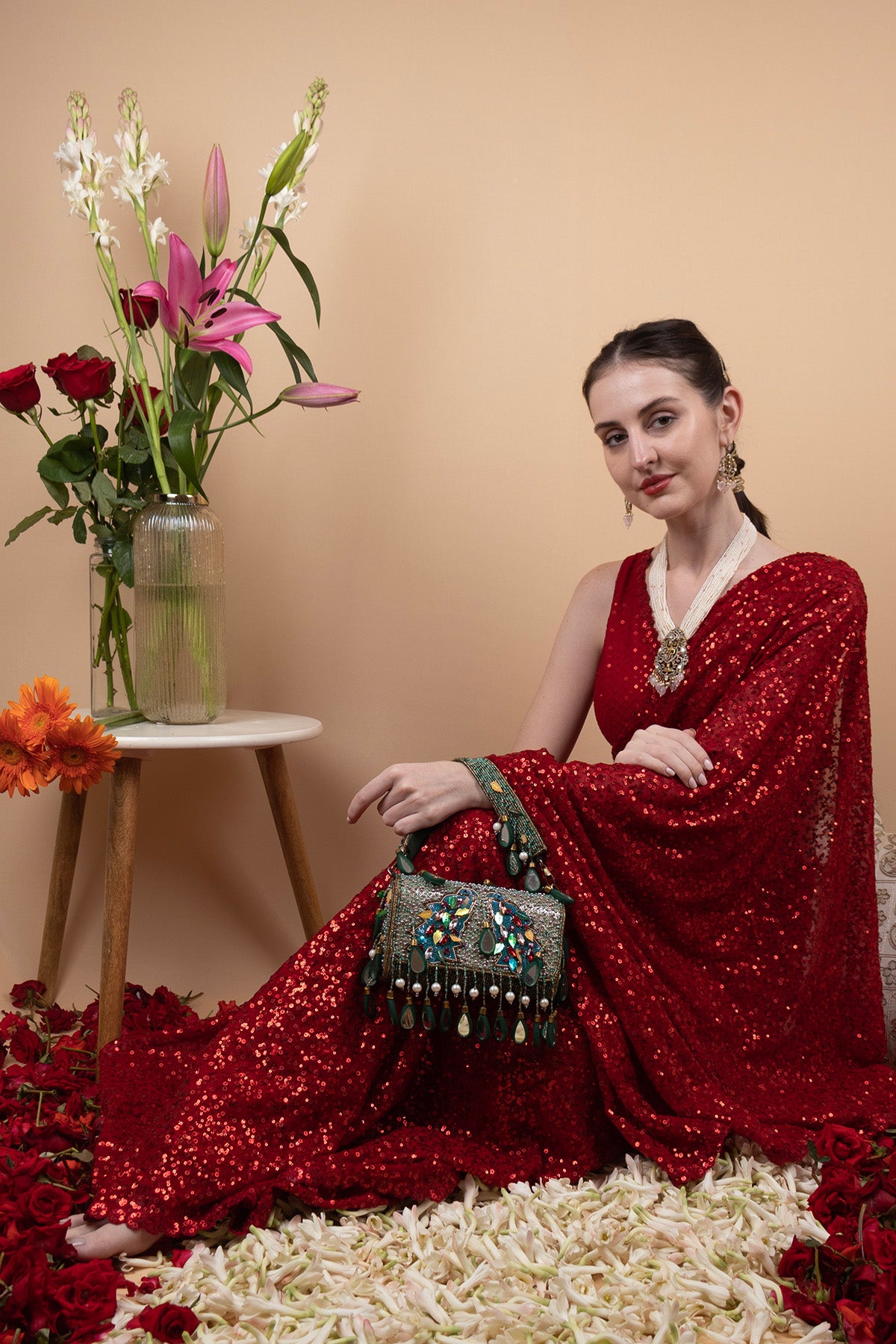Black handcrafted potli bag with sequin cutdana beadwork stones and drawstring closure for festive and wedding wear