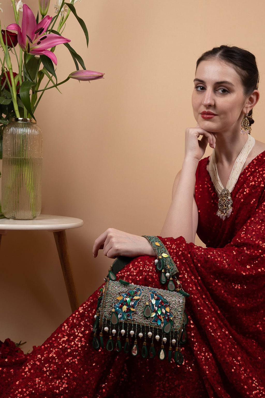 Black handcrafted potli bag with sequin cutdana beadwork stones and drawstring closure for festive and wedding wear