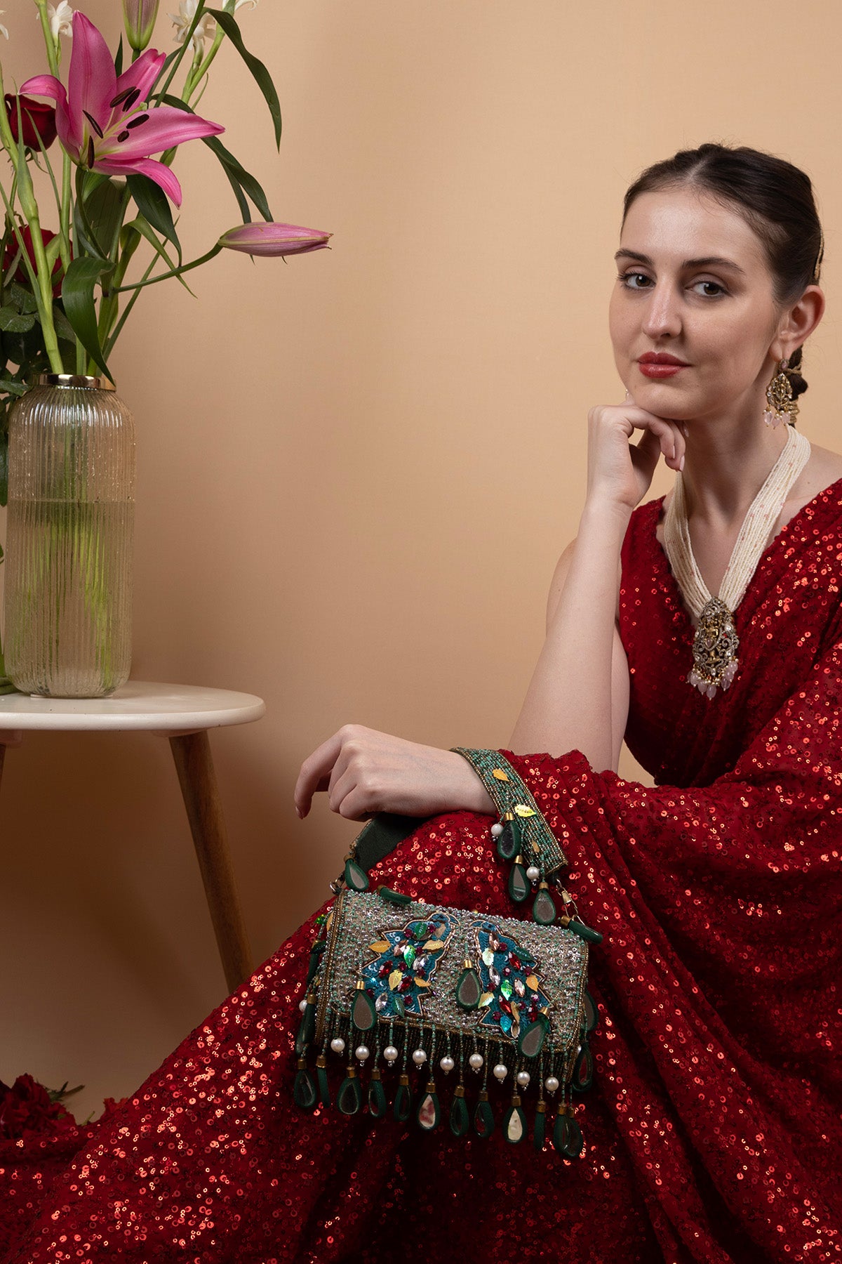 Black handcrafted potli bag with sequin cutdana beadwork stones and drawstring closure for festive and wedding wear