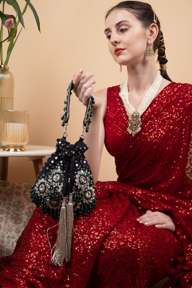 Black handcrafted potli bag with sequin cutdana beadwork stones and drawstring closure for festive and wedding wear Hover Image
