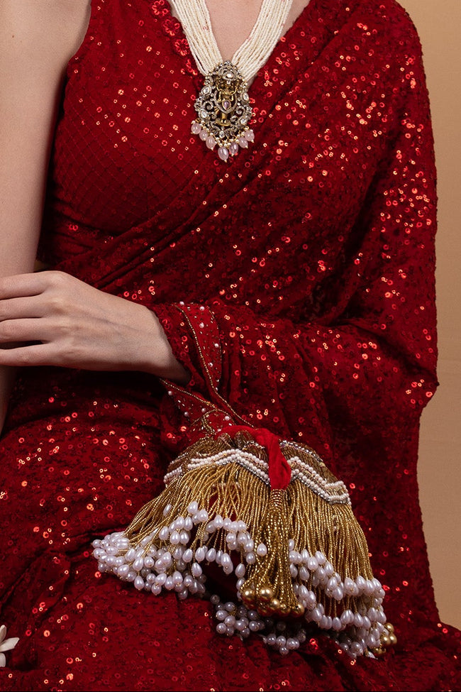 Red velvet potli bag with cutdana pearl and stone embellishments with drawstring and handle for wedding and festive wear Hover Image