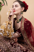 Gold velvet potli bag with cutdana pearl and stone embellishments with drawstring and handle for wedding and festive wear