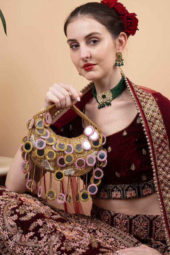 Gold beaded mirror work handle bag with pink accents and mirror embellishments for wedding and festive wear Hover Image