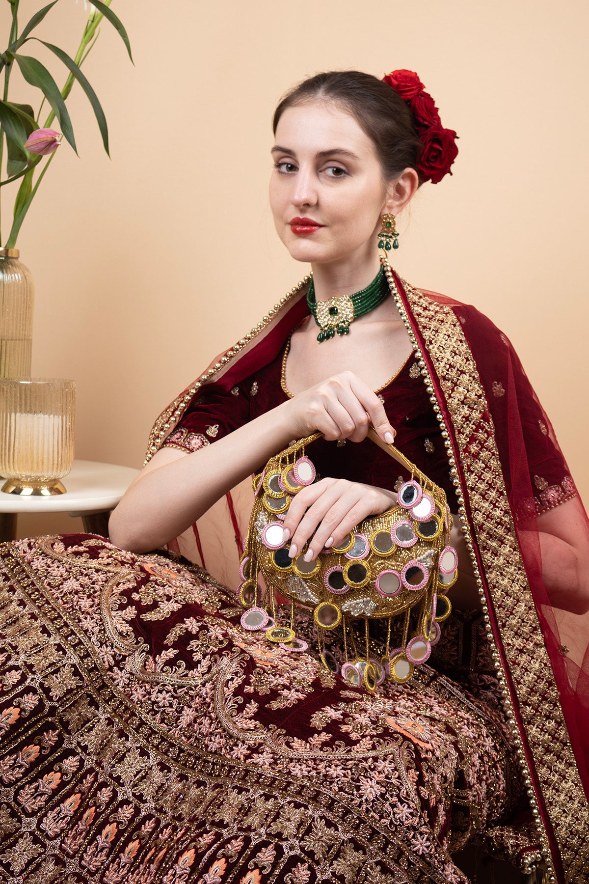 Gold beaded mirror work handle bag with pink accents and mirror embellishments for wedding and festive wear