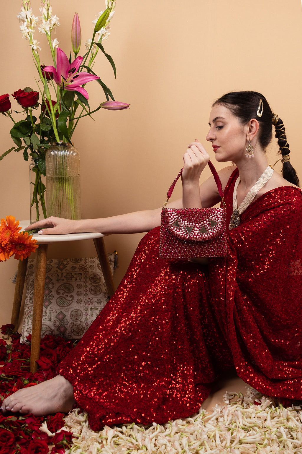 Red mirror work clutch bag with pearl and bead embellishments and suede lining for wedding and festive wear