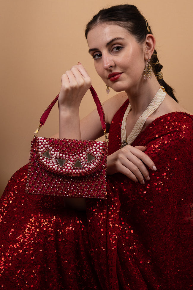 Red mirror work clutch bag with pearl and bead embellishments and suede lining for wedding and festive wear Hover Image