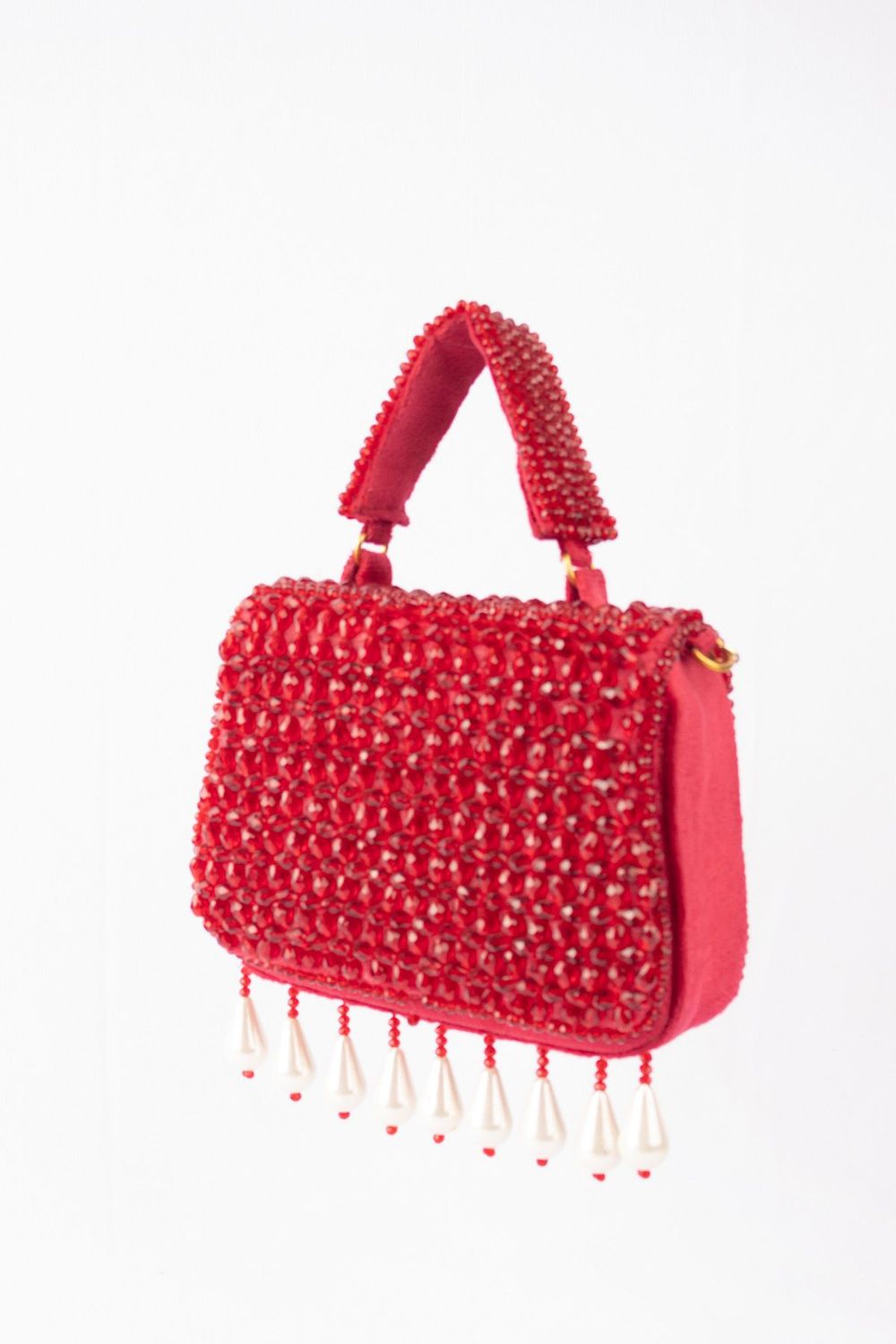 Red crystal embellished evening handbag with structured design handle and chain strap for wedding and festive wear