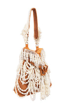 Velvet potli bag with cascading pearl strands, drawstring closure and embellished handle for wedding and festive occasions
