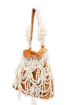 Velvet potli bag with cascading pearl strands, drawstring closure and embellished handle for wedding and festive occasions