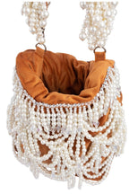 Velvet potli bag with cascading pearl strands, drawstring closure and embellished handle for wedding and festive occasions
