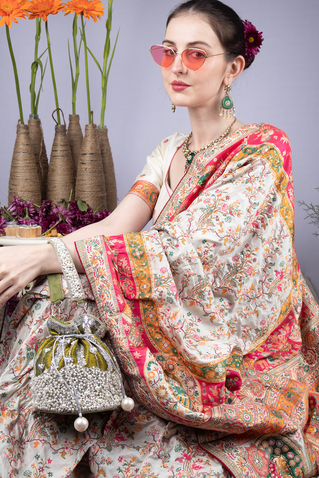 Blue and olive raw silk potli bag with sequins cutdana and pearl embellishments with tassel for wedding and festive wear