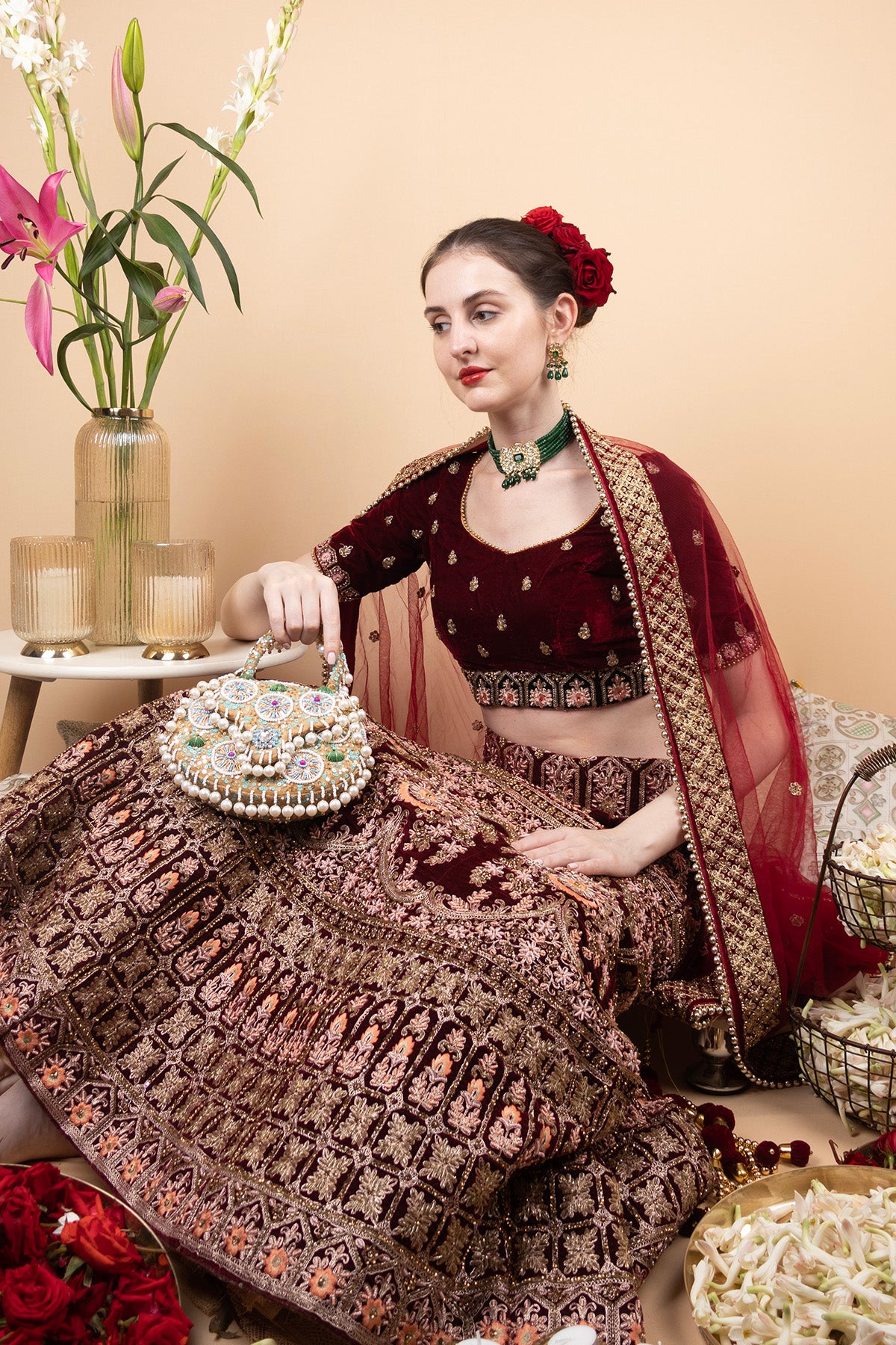 Beige handcrafted potli bag with beads sequins zari embroidery and pearl detailing with chain strap for wedding and festive wear