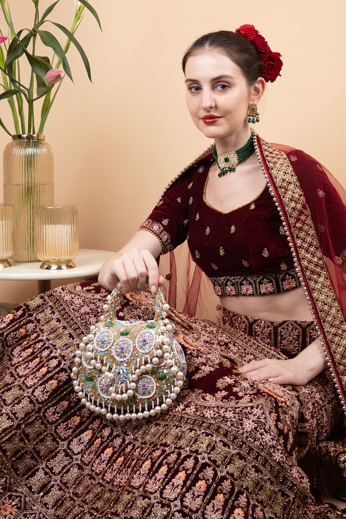 Beige handcrafted potli bag with beads sequins zari embroidery and pearl detailing with chain strap for wedding and festive wear