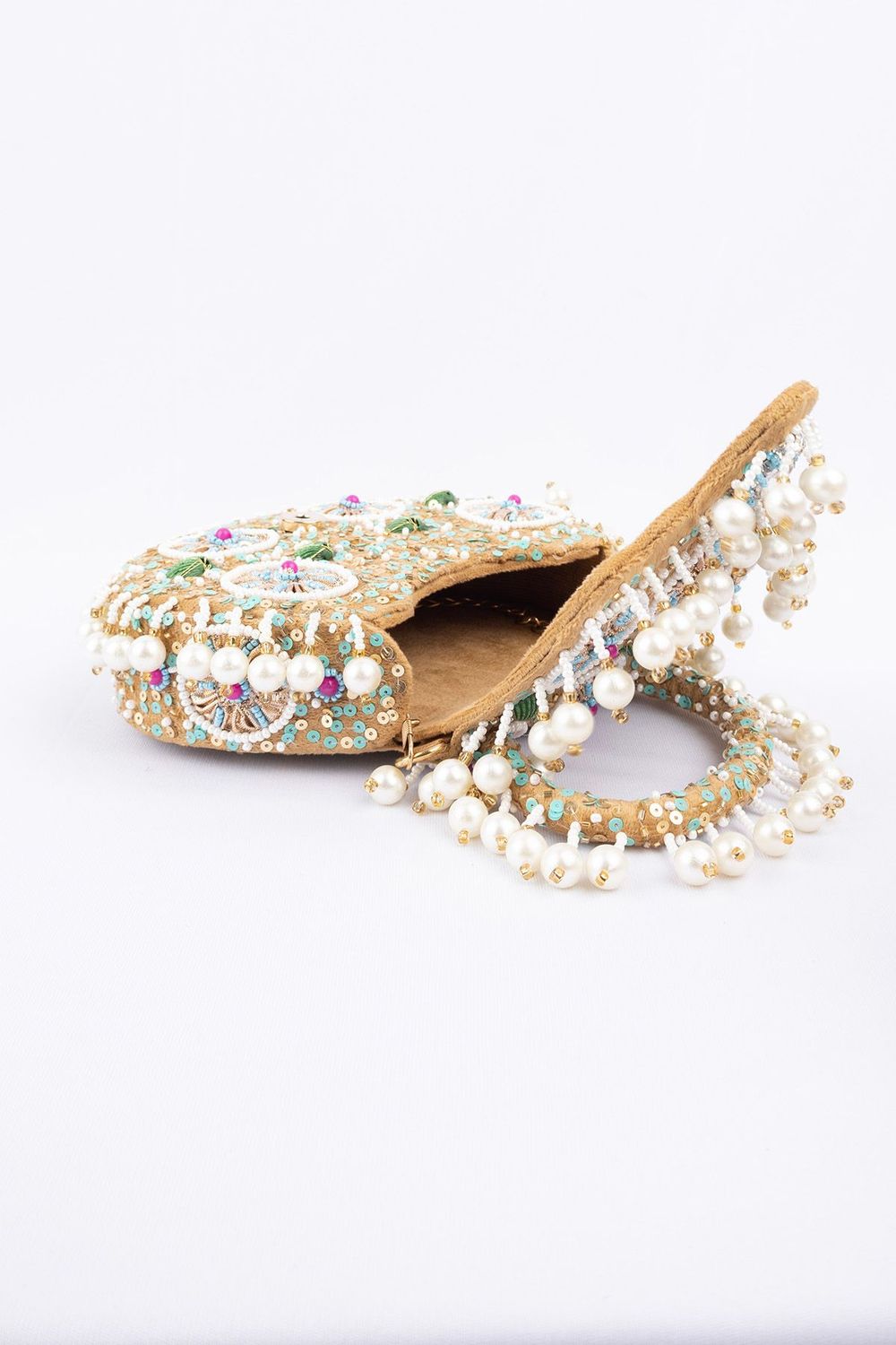 Beige handcrafted potli bag with beads sequins zari embroidery and pearl detailing with chain strap for wedding and festive wear