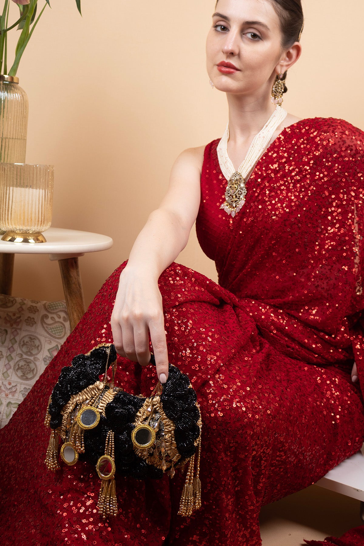 Black beaded floral mirror work clutch bag with handcrafted detailing and suede lining for wedding and festive wear