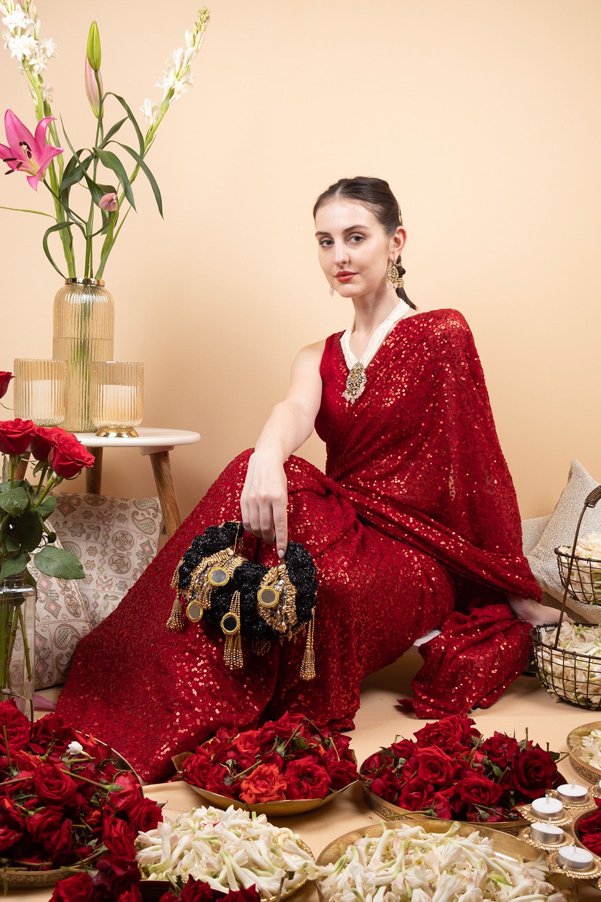 Black beaded floral mirror work clutch bag with handcrafted detailing and suede lining for wedding and festive wear