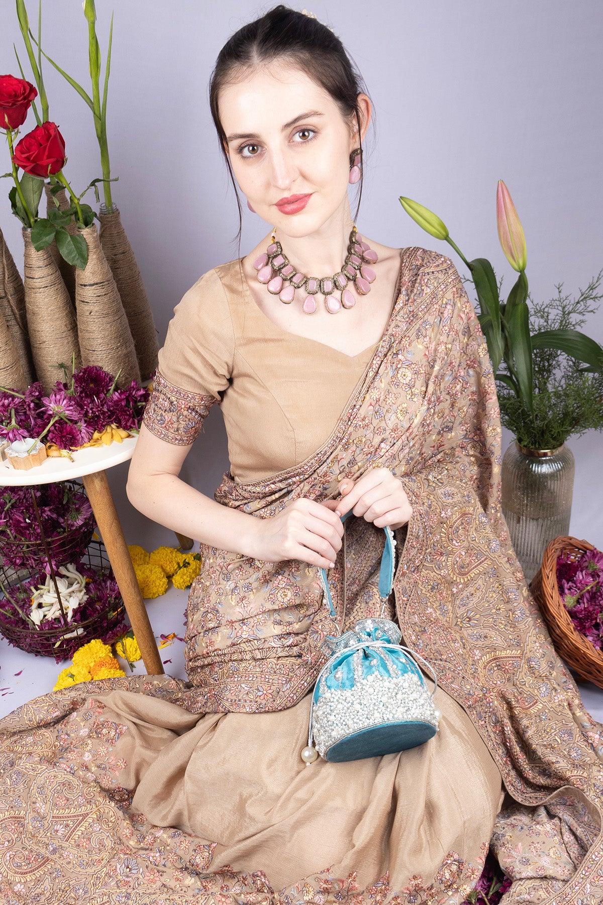 Blue raw silk potli bag with sequins cutdana and pearl embellishments with tassel for wedding and festive wear