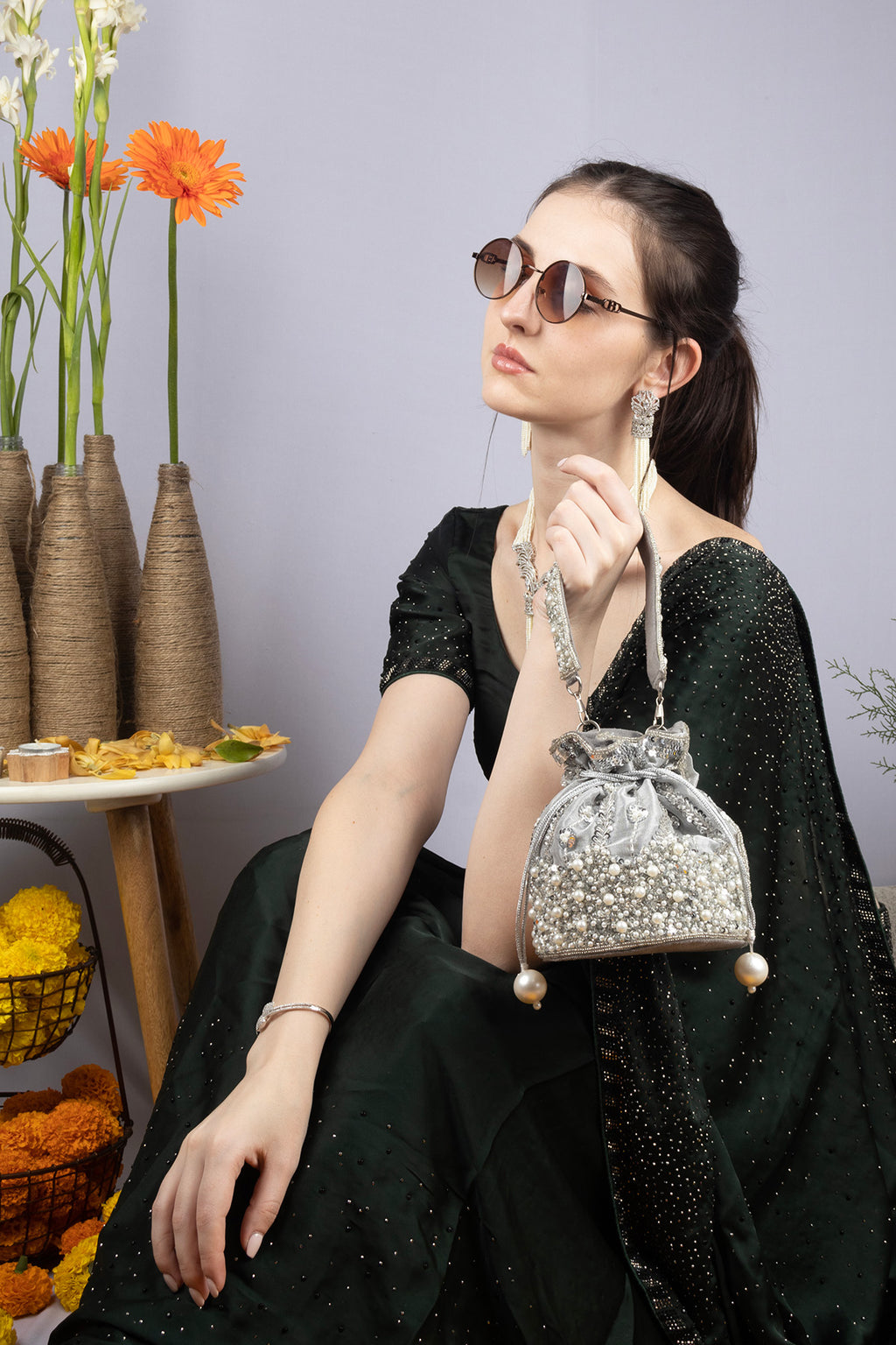 Silver potli bag with cutdana pearl and sequin embellishments on raw silk fabric with tassel for wedding and festive wear