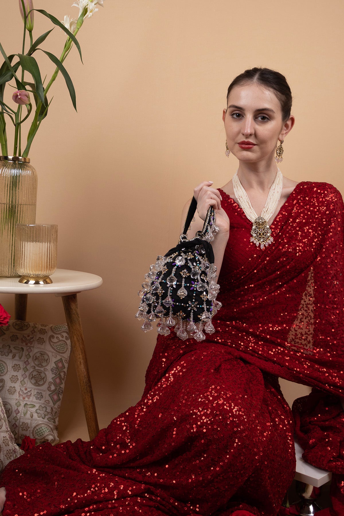 Black velvet potli bag with crystal dangling stones and bead embellishments for wedding and festive wear