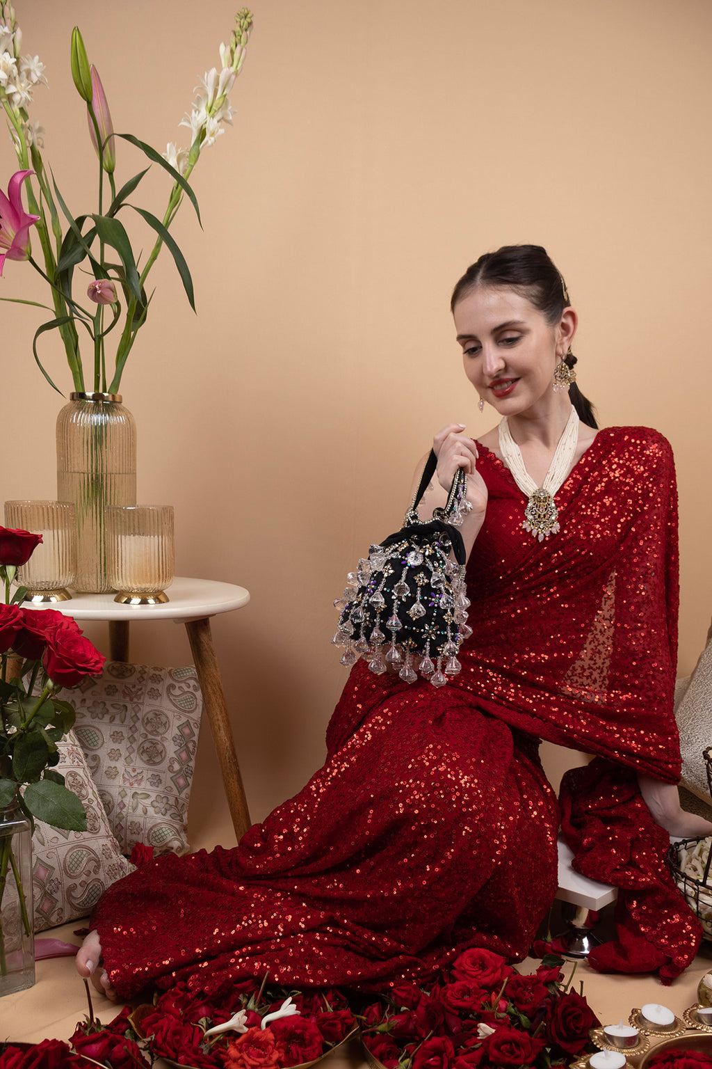 Black velvet potli bag with crystal dangling stones and bead embellishments for wedding and festive wear