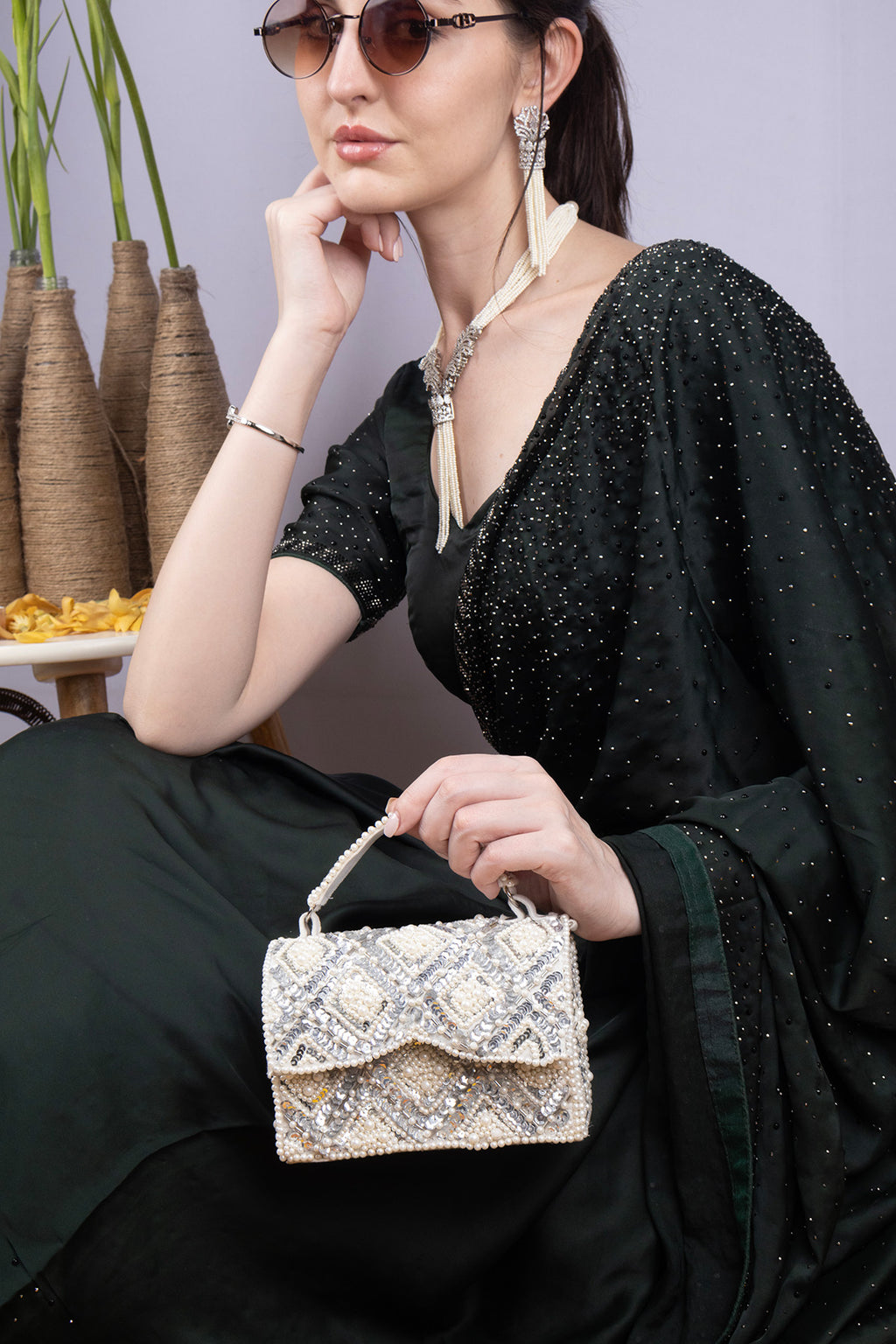 Handcrafted clutch with pearl and sequin geometric embellishment structured design short handle and detachable shoulder chain for wedding and festive wear