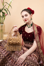 Gold handcrafted evening handbag with Cut Dana floral embroidery, pearl and bead detailing with tassels for wedding and festive wear