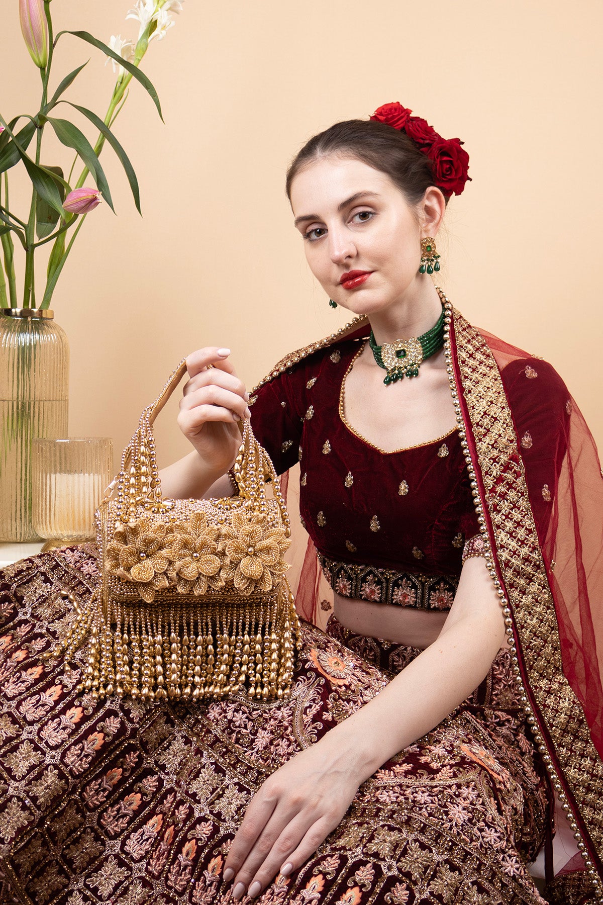 Gold handcrafted evening handbag with Cut Dana floral embroidery, pearl and bead detailing with tassels for wedding and festive wear