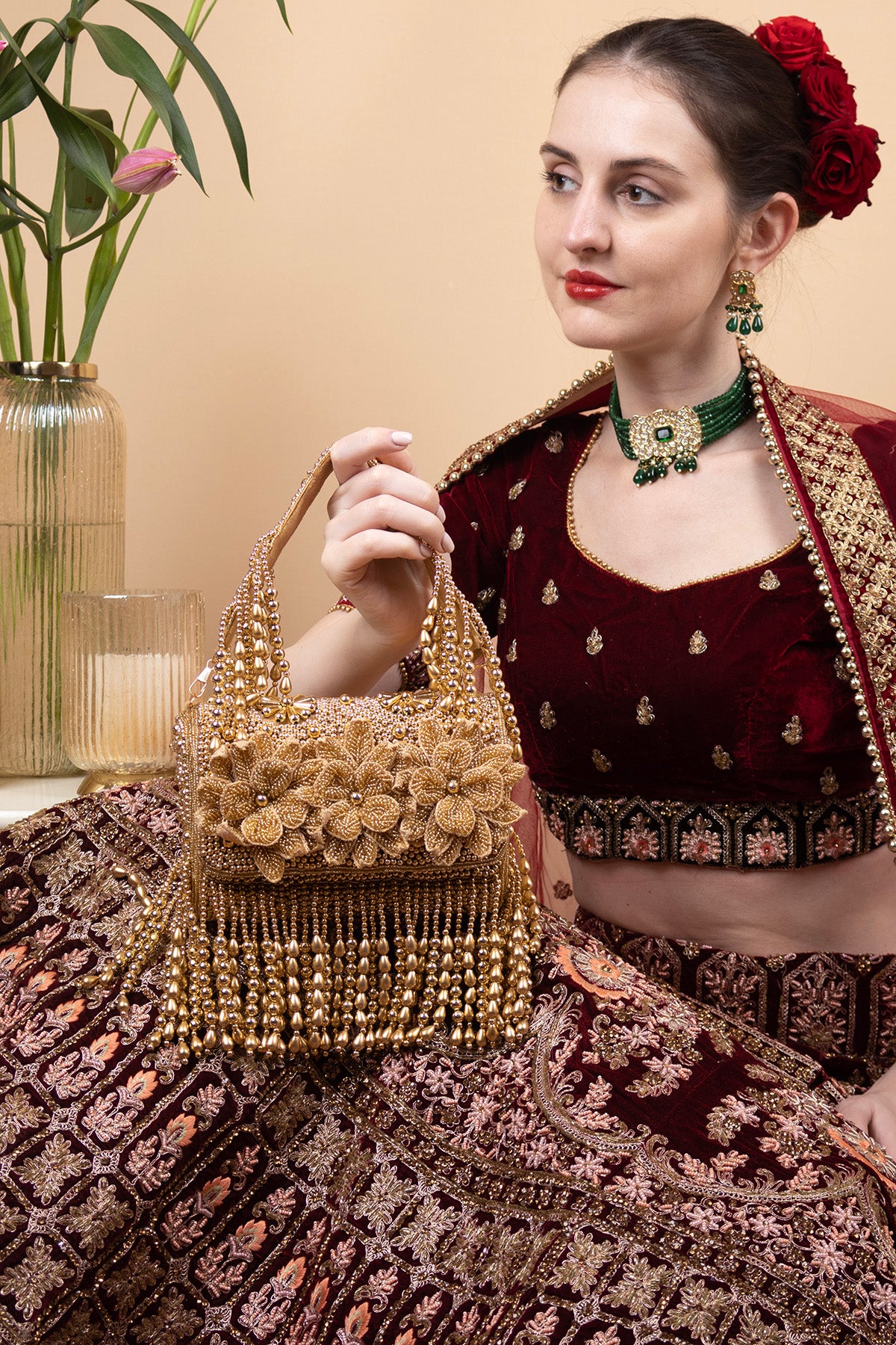 Gold handcrafted evening handbag with Cut Dana floral embroidery, pearl and bead detailing with tassels for wedding and festive wear