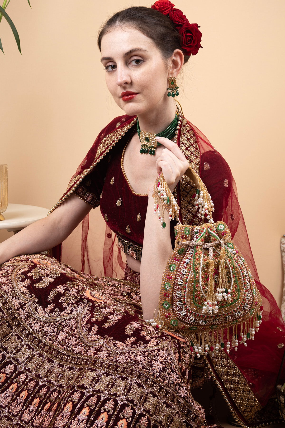 Gold green handcrafted potli bag with beads, stone and pearl work for wedding and festive wear