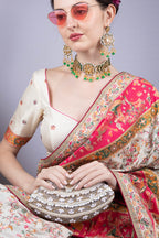 Ivory oval clutch bag with pearl crystal and cutdana embellishment raw silk lining and detachable chain for wedding and festive wear